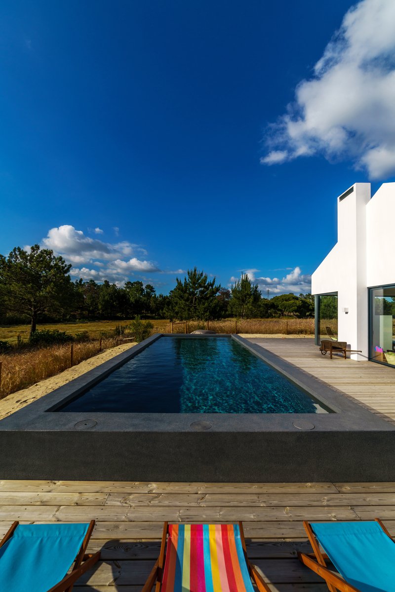 Modern house with garden swimming pool and wooden deck
